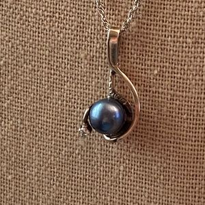 Black pearl and diamond treble clef silver necklace